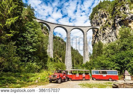 Filisur, Switzerland - July 29, 2019: Red Tourist Car Near Landwasser Viaduct. This Place Is Landmar