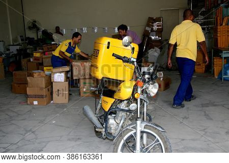 Eunapolis, Bahia / Brazil - April 1, 2008: Correios Employees Sort Orders For Delivery In The City O