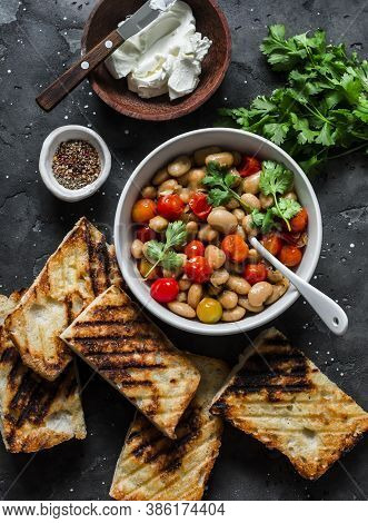 Ingredients For  Goats Cheese Crostini With Garlicky Beans On A Dark Background, Tp View