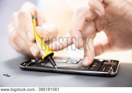 Russia - July 27, 2020: Repair Iphone Apple Broken Phone Screen And Replace Used Rechargeable Batter