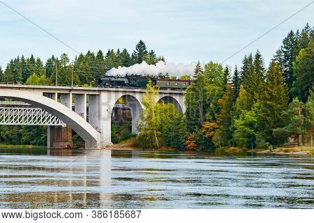 Kouvola, Finland - 18 September 2020: Autumn Landscape Of Bridge With Moving Old Steam Passenger Tra
