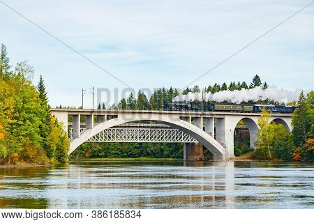 Kouvola, Finland - 18 September 2020: Autumn Landscape Of Bridge With Moving Old Steam Passenger Tra
