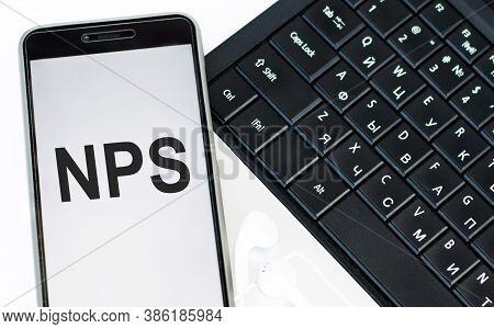 Phone With The Text Nps Net Promoter Score On The Laptop Keyboard. Business Concepts