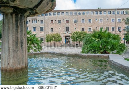 Ancient Stone Fountain Surrounded By Nature, Located At The Entrance Of The Monastery Of Lluc, Islan