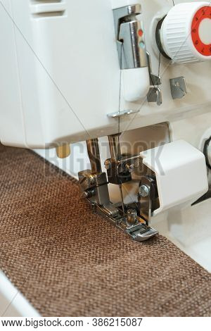 Overlock Sewing Machine In Process. Professional Equipment