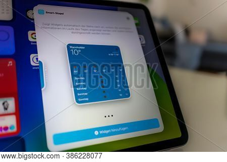 Frankfurt, Germany - September 17th 2020: A German Photographer Installing The All New Ipados 14 Sof