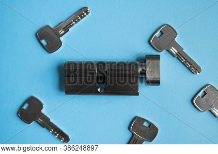 A Door Lock Cylinder Core With Keys On The Blue Background. The Cylinder Of The Lock With Keys. Inst