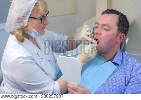 Dentist Woman Teaching Patient To Clean Teeth Using Dental Floss In Dentistry. Stomatologist Cleanin