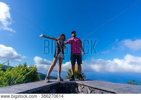 A Very Happy Couple On Top Of The Mountain At The Viewpoint Of The Cubo De La Galga Natural Park On 