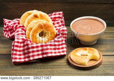 Pandequeso Traditional Colombian Food - Hot Drink Chocolate. Wood Background