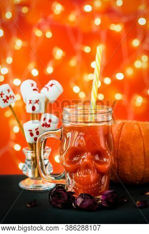 Glass Mug Skull With Red Tomato Juice. A Welcome Cocktail At A Halloween Party. Marshmello Scary Fac