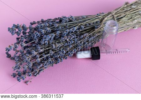 Bouquet Of Dried Lavender Flowers On A Pink Background. Glass Ampoules On Which Chloride 5ml Is Writ