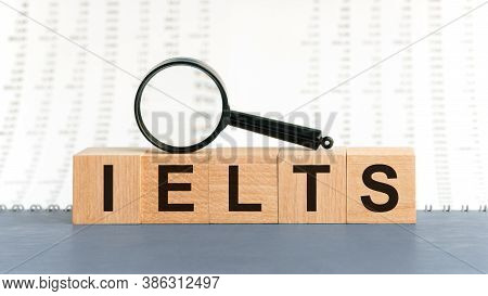 On Wooden Blocks Under A Magnifying Glass Text: Ielts. Ielts - Words From Wooden Blocks With Letters