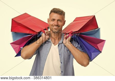 Avid Shopaholic. Happy Man With Packages After Shopping. Handsome Man Care Heavy Shopping Bags. Buy 