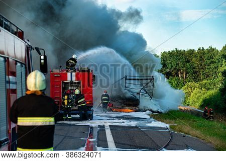 Firefighters Put Out The Fire With Foam In The Car, Fire Engine Extinguishes A Fire On The Road