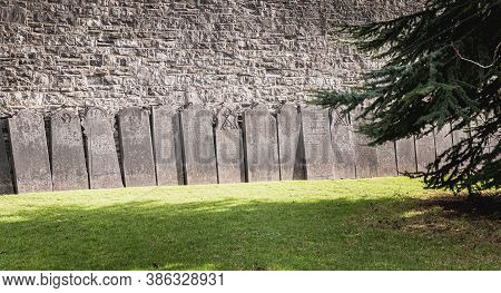 Dublin, Ireland - February 13, 2019: Tombstones Laid Against A Wall In The Cemetery At Arbor Hill Ne