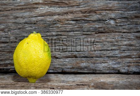 Yellow Lemons On Aged Wooden Background