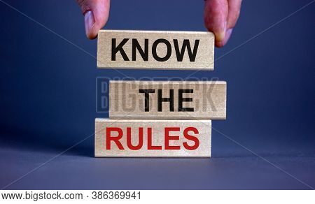 Male Hand Placing A Block With Word 'know' On Top Of A Blocks Tower With Words 'know The Rules'. Bea