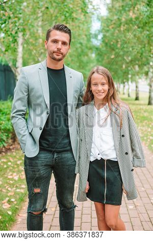 Father And Cute Daughter Outdoor At Fall