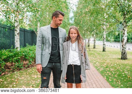 Father And Cute Daughter Outdoor At Fall
