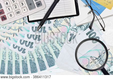 100 Czech Korun Bills And Calculator With Glasses And Pen. Tax Payment Season Concept Or Investment 