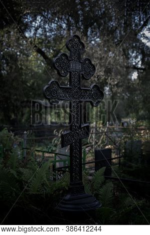 Black Grave Cross, Low Key, Twilight Twilight Nightfall Evening Night. Gloomy Scary Photo, Cemetery 