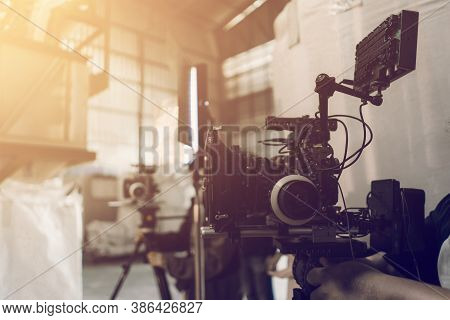 Video Production And Film Crew Team With Camera Equipment Indoor Location And Light Flare Effect. Vi