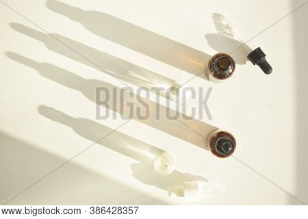 Cosmetic Fragrance Oils In Bottles With Pipette On The Background Of Natural Wood And Pastel Colors.
