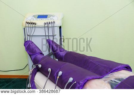 Pressotherapy In The Spa Salon For The Beauty And Health Of The Legs. A Procedure For Treating Legs 