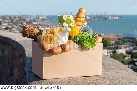 Food Contactless Delivery Uring Quarantine Concept. Box Full Of Fresh Groceries Outdoor