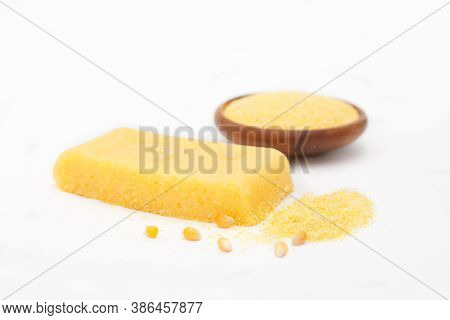 Corn Polenta Slice With Grinded Corn In A Bowl On White Background. Homemade Palenta, Healthy Vegeta
