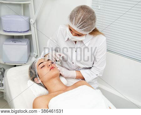 Woman Getting Cosmetic. Injection. Beauty Injections And Cosmetology.  Young Woman In Beauty Salon S
