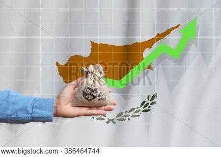 The Concept Of Economic Growth In Republic Of Cyprus. Hand Holds A Bag With Money And An Upward Arro