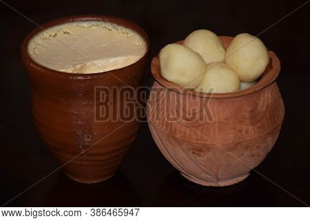 Traditional Indian Bengali Sweet Misti Doi (sweet Curd) With Rosogolla Served In Earthen Pots