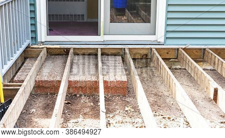The Frame Is Set For A New Deck To Be Installed On The Back Of A House Over The Old Stoop In Front O