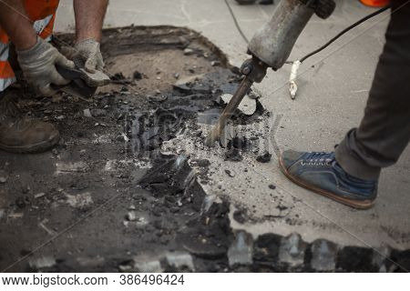 Removal Of Asphalt. Road Surface Repair. Working With A Jackhammer. The Road Repair Crew Broke The A