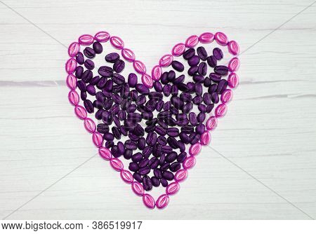Heart Of Coffee Beans On A Wooden Background