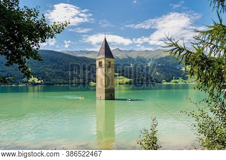 The Famous Bell Tower In The Lake Of Reschen - Lago Di Resia In South Tyrol, Italy. During Ww2 A Dam