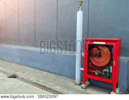 Fire Extinguishers Prepare In The Event Of Fire, Fire Protection Equipment In A Red Box Beside The C