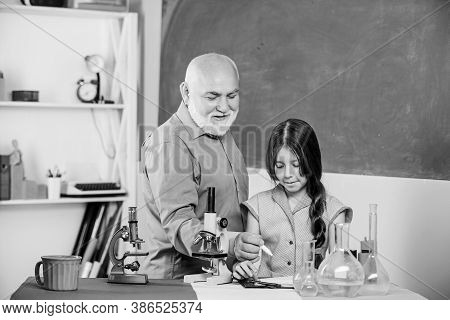 Little Girl With Man Tutor Study Science. Pedagogue Career. Experienced Pedagogue. School Lesson. Go