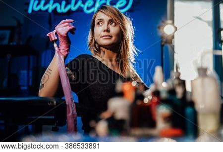 Modern Tattoo Studio With Spotlight And Neon Lights And Attractive Female Tattoo Master Shes Posing 