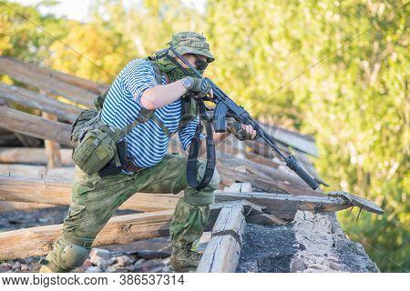 The Airsoft Player Holds The Defense, Takes Aim At The Enemy