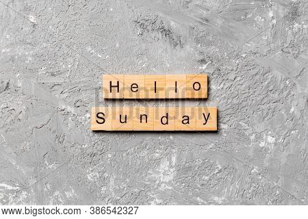Hello Sunday Word Written On Wood Block. Hello Sunday Text On Cement Table For Your Desing, Concept