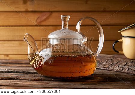Teapot With Brewed Hot Tea On A Wooden, Cozy Background