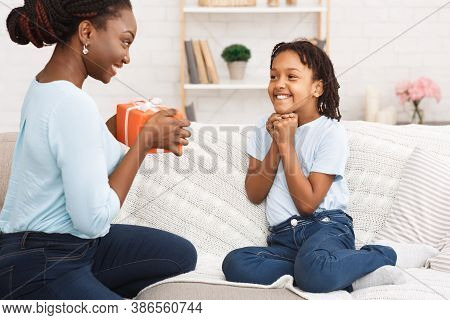 Congatulations. Black Mother Making Birthday Gift For Daughter, Excited Girl Waiting For Present
