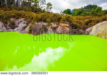  Devil's Bath with bright green color of water. Volcanic Valley Waimangu, Wai-O-Tapu. The unique geothermal area of Rotorua. New Zealand, North Island. Extreme, exotic and photo tourism concept