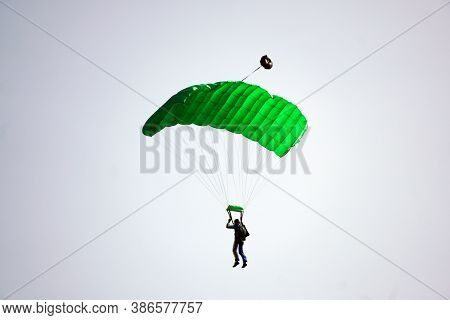 Parachutist Jamped From An Airplane Uses A Parachute To Land.