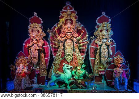 Decorated Durga Puja Pandal With Goddess Durga Family Idol, Durga Puja Festival At Night. Shot Under