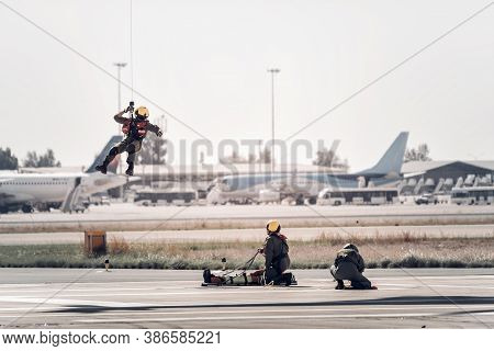 A Man Is Winched Up To A Hovering Search And Rescue Helicopter During A Sars Training Rescue