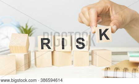 Risk Word Written On Wooden Cubes. Financial Risk Assessment, Risk Reward And Portfolio Risk Managem